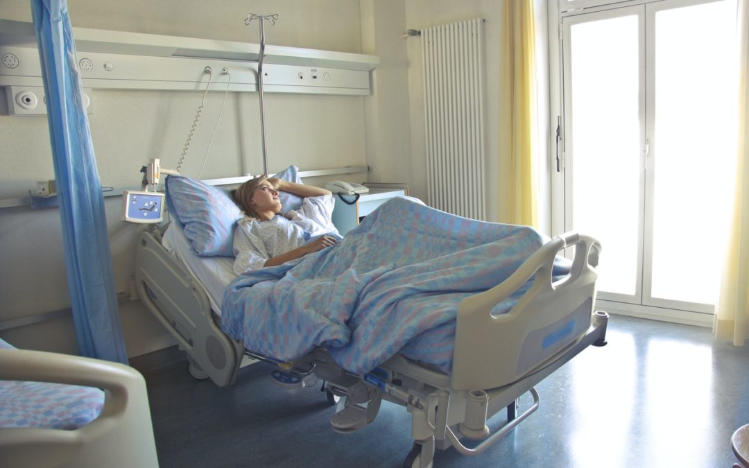 medical malpractice settlement - woman laying in hospital bed