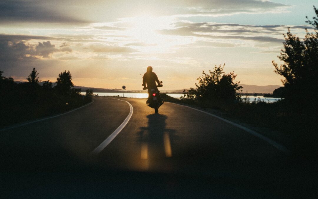 person riding motorcycle during golden hour