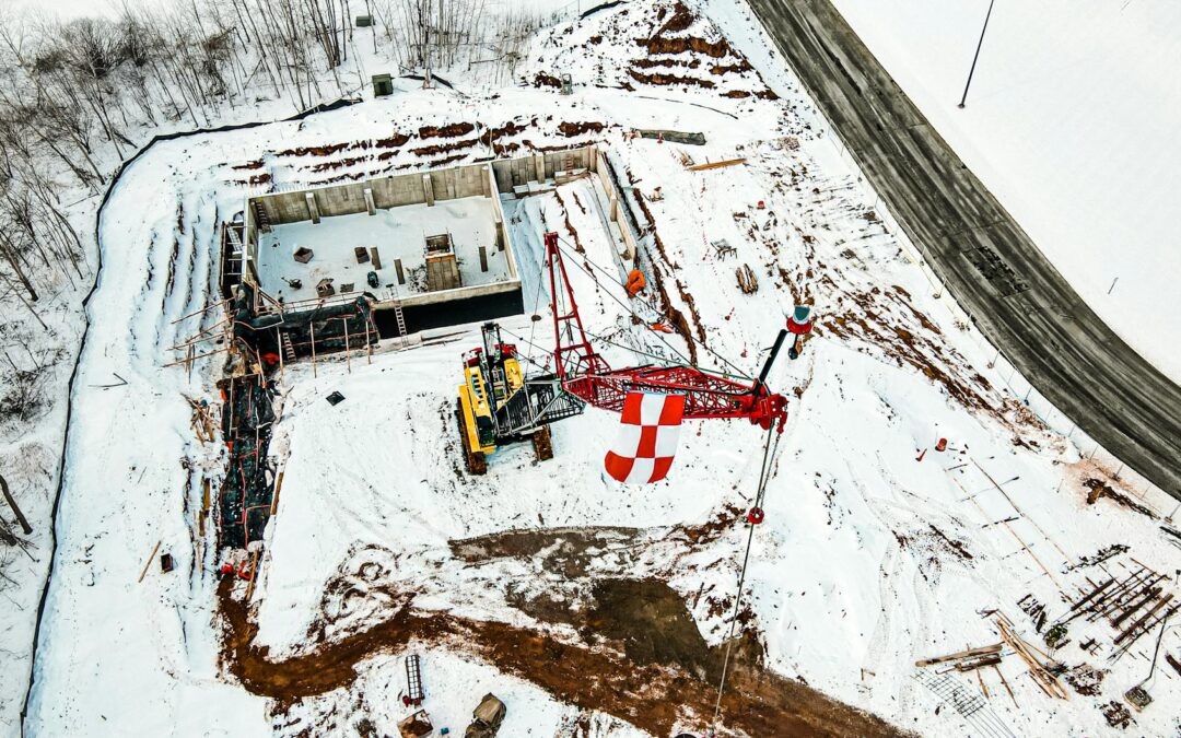 a crane equipment at a construction site on snow covered ground
